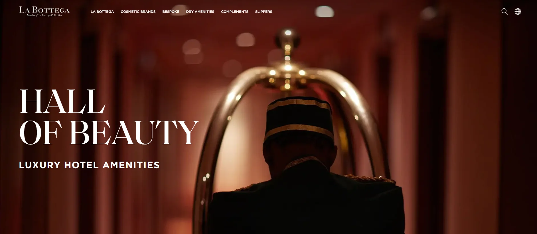 Luxury hotel amenities with bellhop trolley in dimly lit hallway.